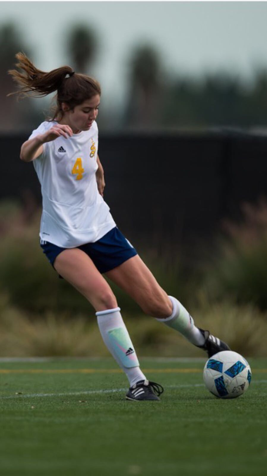 Soccer player kicking ball after treating with Tustin Chiropractor