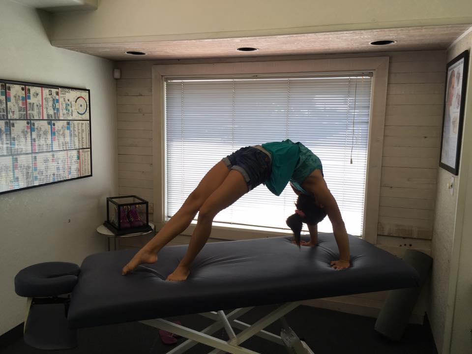 Gymnastics star doing high back bridge at Tustin chiropractors facility